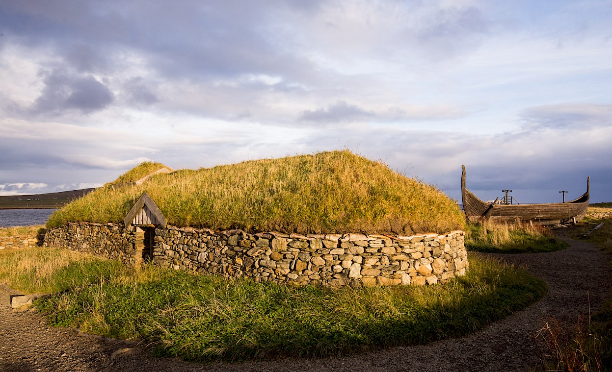 The Skidbladner (a replica Viking ship), and Viking Longhouse reconstruction, at Haroldswick